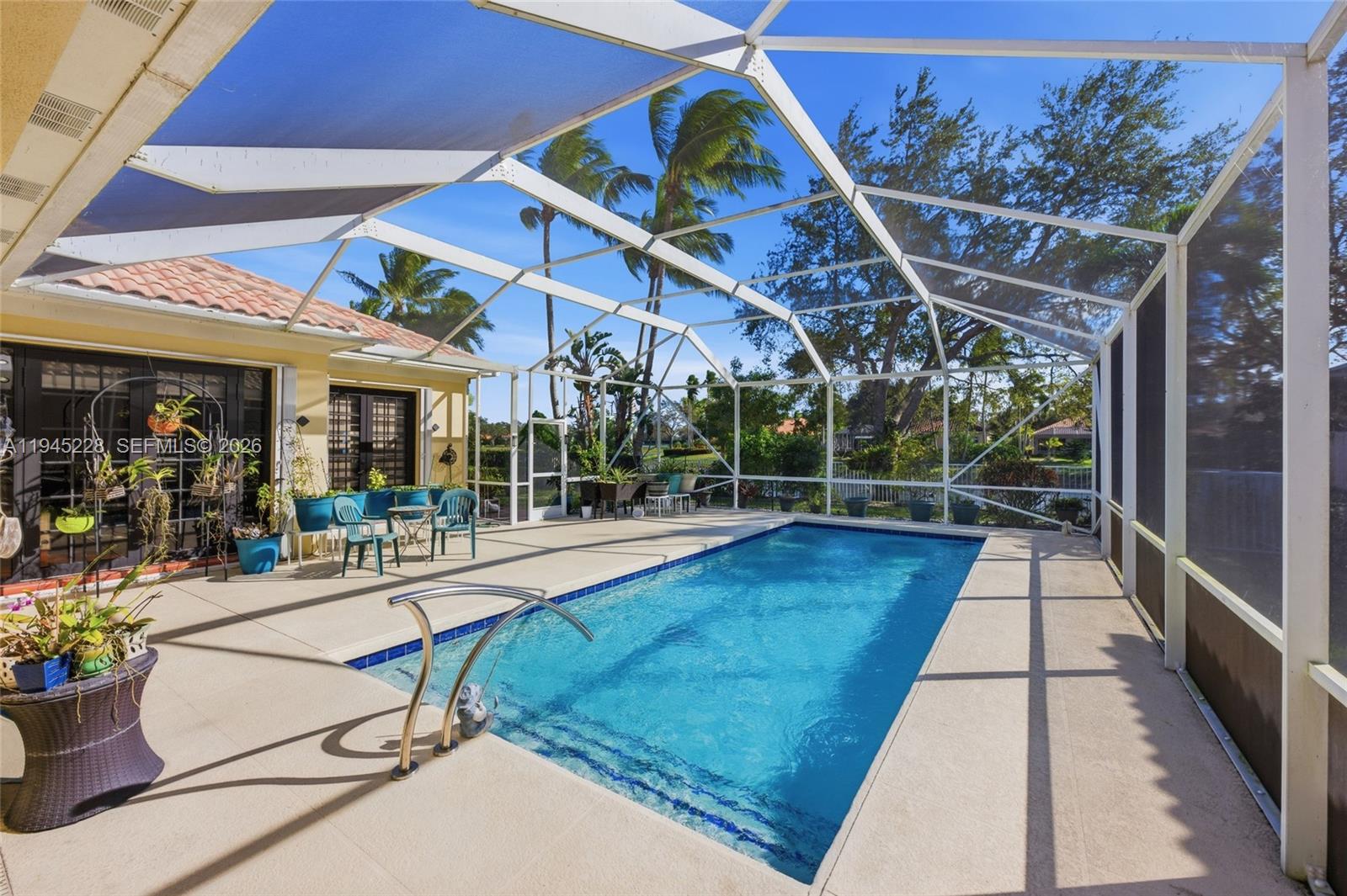 7646 Red River Road West Palm Beach, FL 33411 - Photo 48 of 69 a view of a patio with a table and chairs under an umbrella