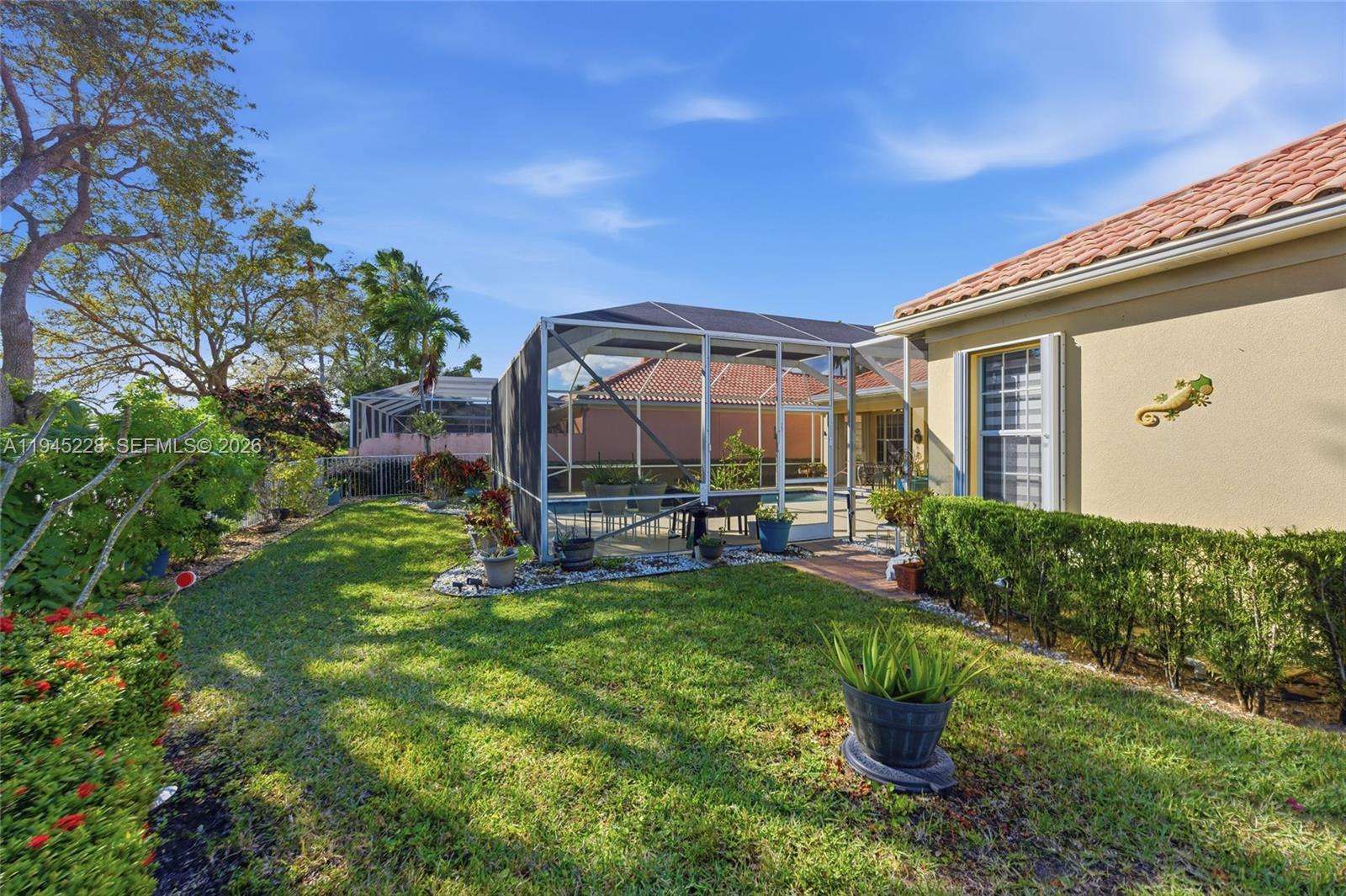 7646 Red River Road West Palm Beach, FL 33411 - Photo 55 of 69 a view of a chair and table in backyard of the house