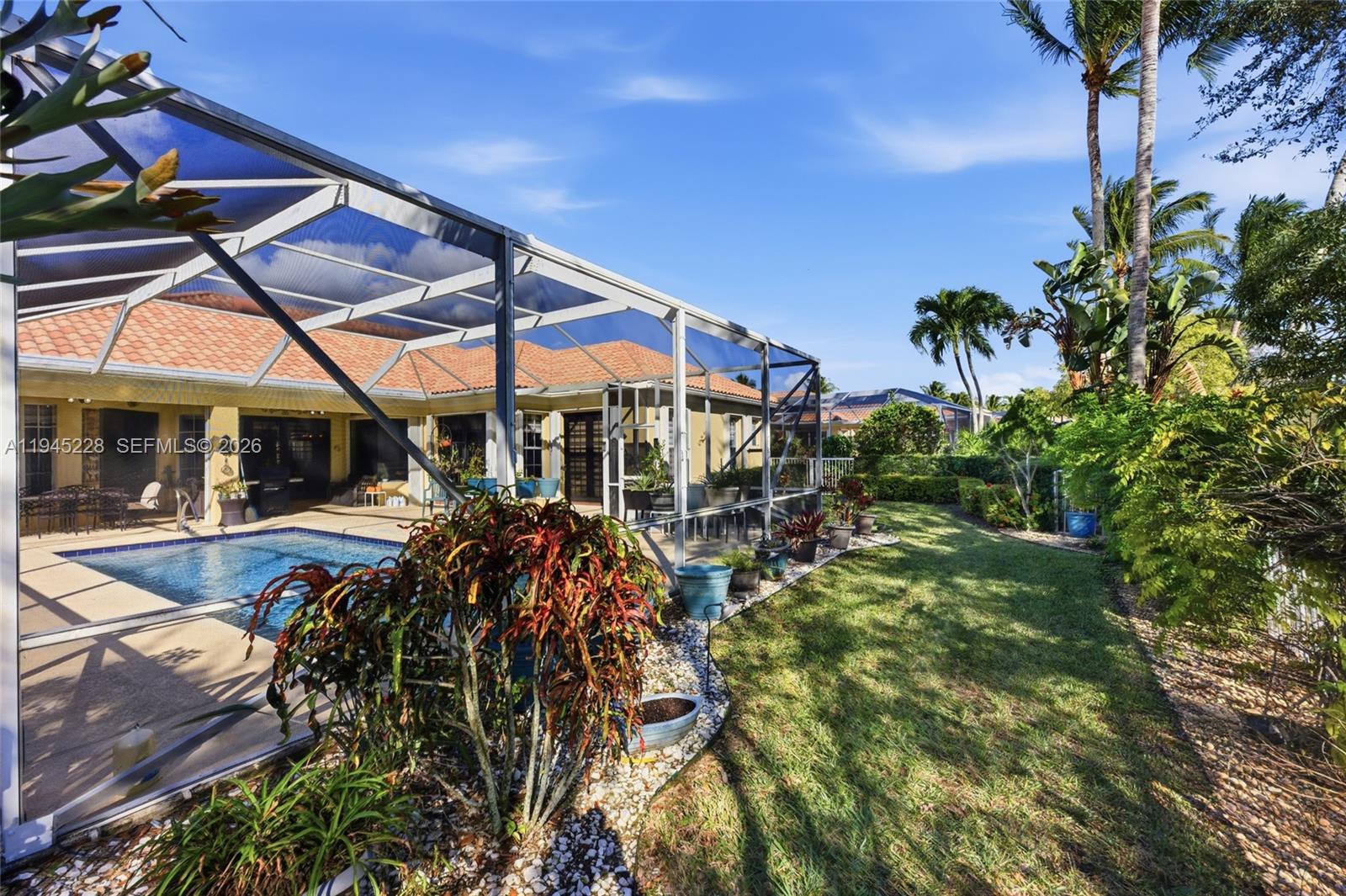 7646 Red River Road West Palm Beach, FL 33411 - Photo 56 of 69 a view of a house with a yard porch and sitting area