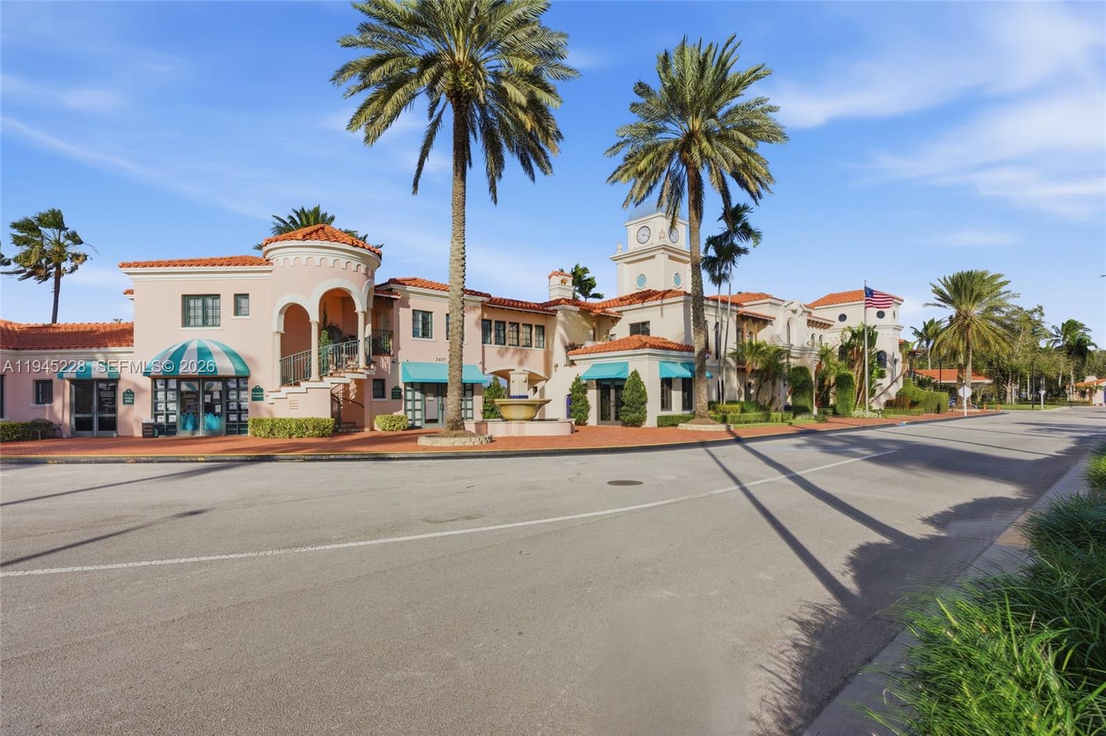 7646 Red River Road West Palm Beach, FL 33411 - Photo 58 of 69 front view of a house with a yard and palm trees