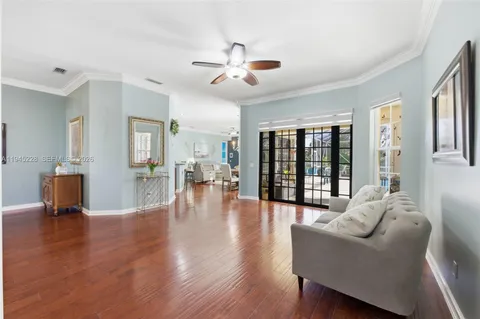 a living room with furniture and a wooden floor