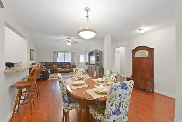 a view of a dining room with furniture and wooden floor