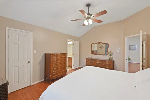 a bedroom with a large bed and a chandelier