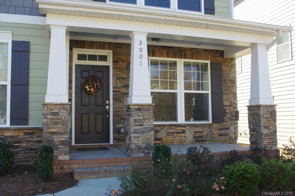 2001 Fallondale Road, Unit 919 Waxhaw, NC 28173 - Photo 3 of 24 a front view of a brick house with a yard