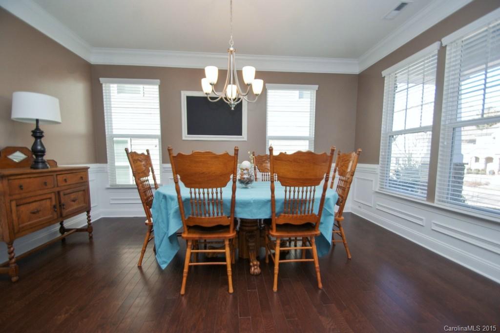 2001 Fallondale Road, Unit 919 Waxhaw, NC 28173 - Photo 5 of 24 a dining room with furniture a chandelier and wooden floor