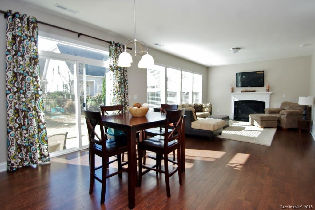 2001 Fallondale Road, Unit 919 Waxhaw, NC 28173 - Photo 6 of 24 a living room with furniture dining table and a fireplace