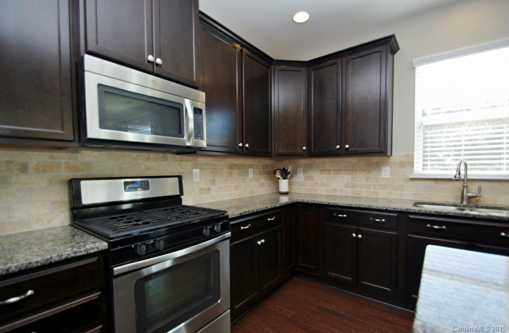 2001 Fallondale Road, Unit 919 Waxhaw, NC 28173 - Photo 8 of 24 a kitchen with a sink stove and microwave