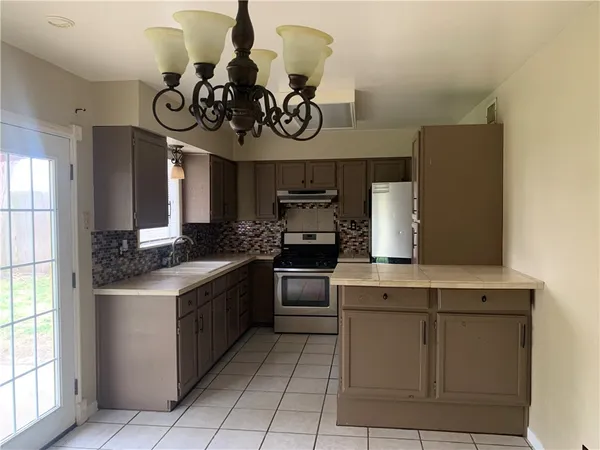 a kitchen with a stove and a refrigerator