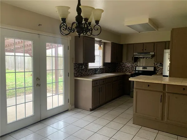 a kitchen with a sink cabinets and window