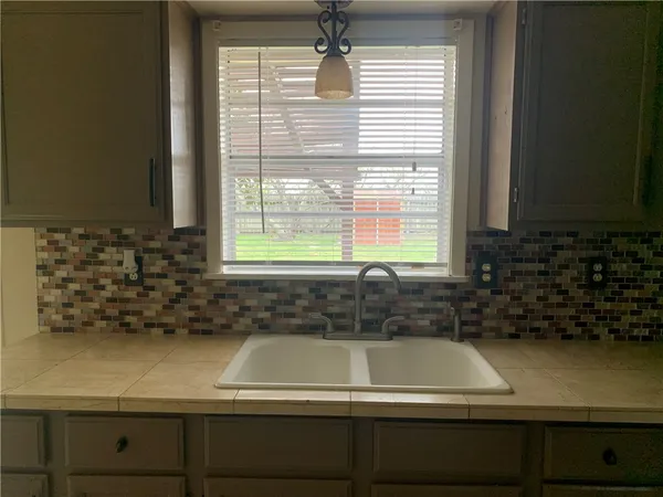 a bathroom with a bathtub and a window