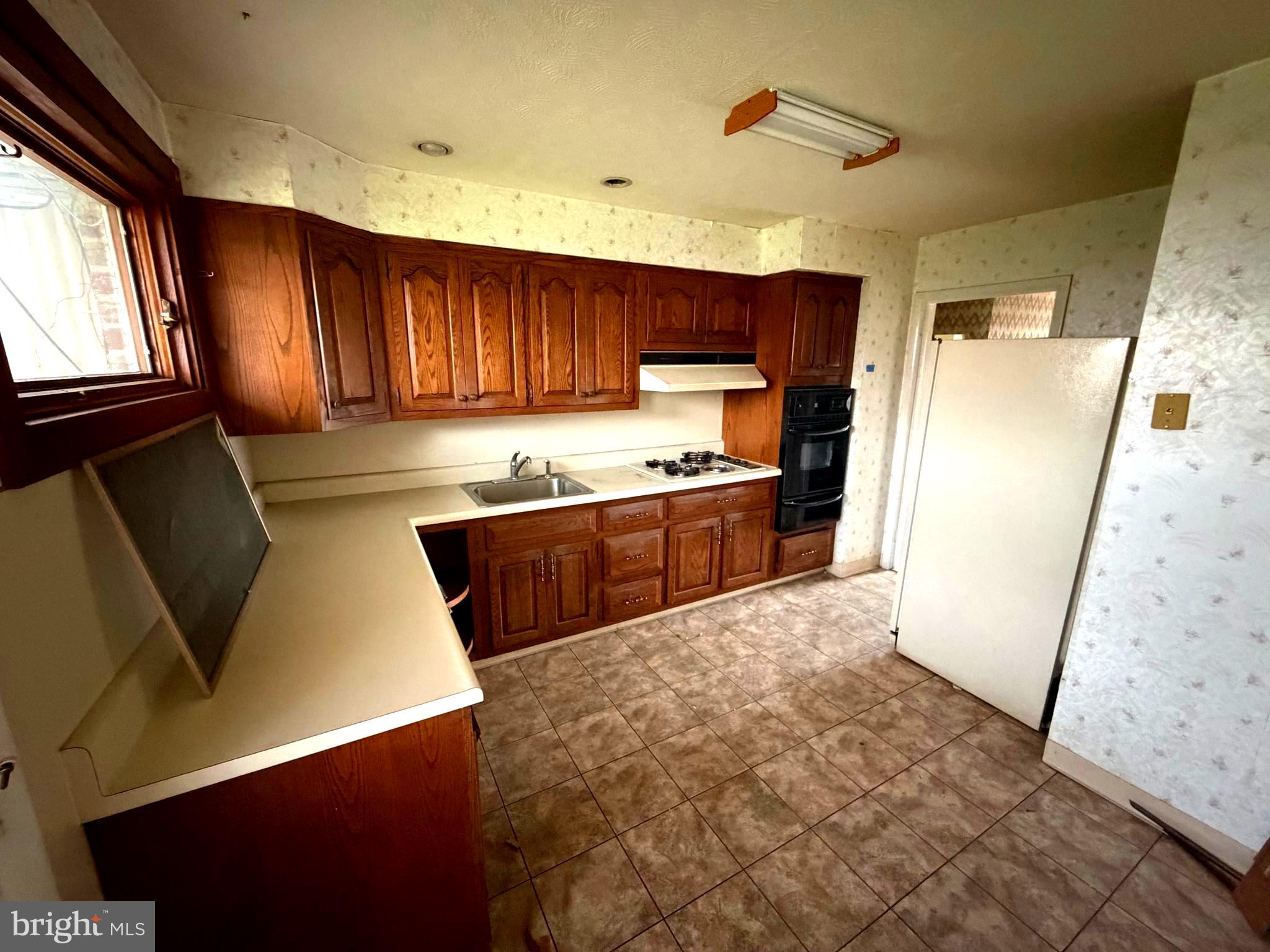 9610 Dedaker Street Philadelphia, PA 19115 - Photo 7 of 22 a kitchen with stainless steel appliances granite countertop a refrigerator sink and cabinets