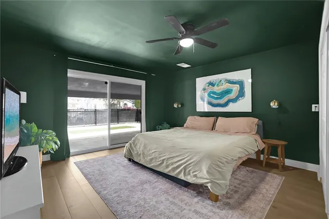 a spacious bedroom with a bed and a large window