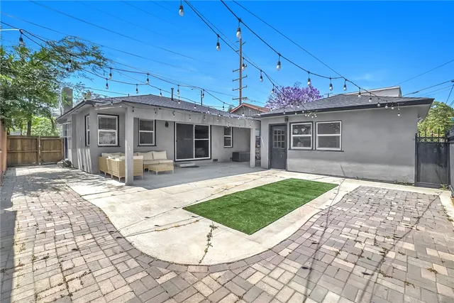 a front view of a house with a garden and yard