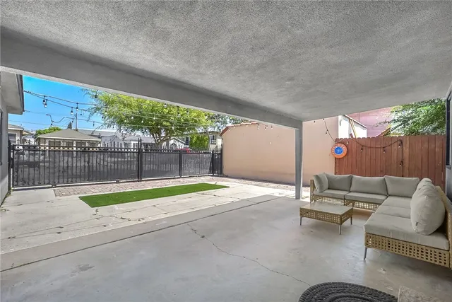 a backyard of a house with yard and outdoor seating