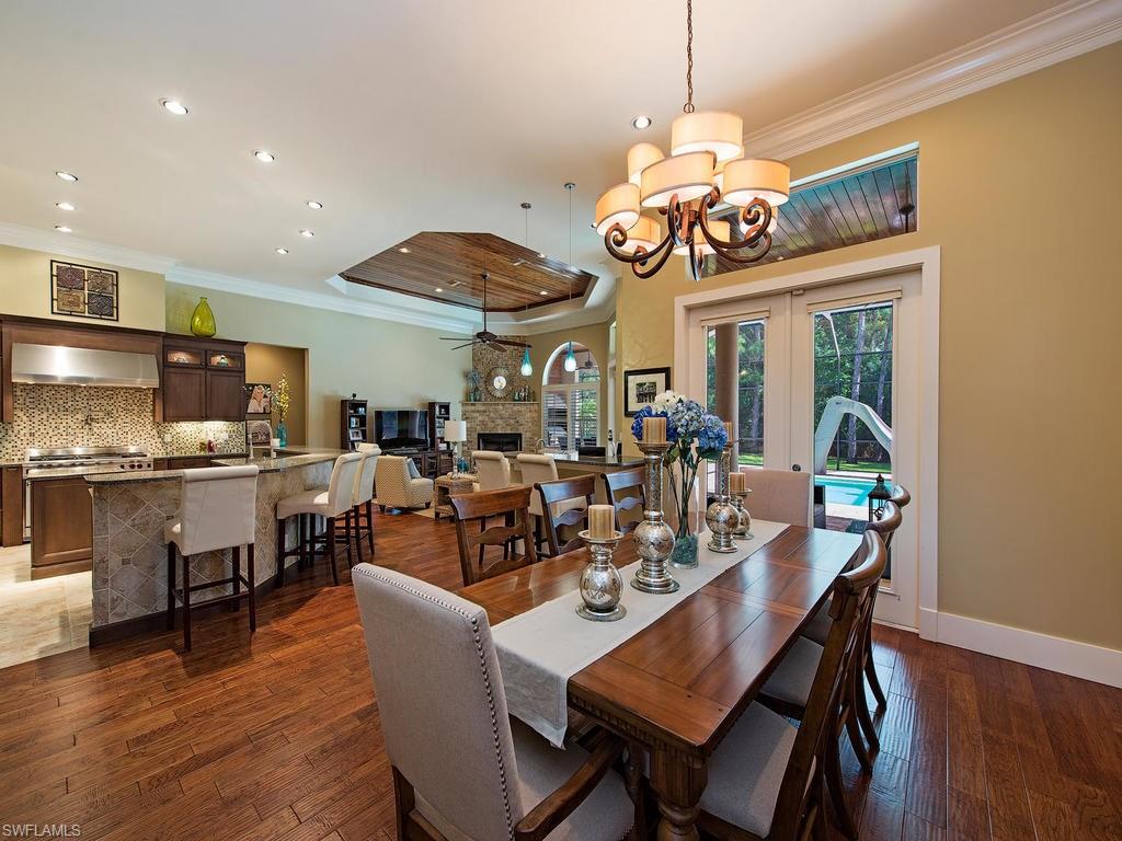 59 Myrtle Road Naples, FL 34108 - Photo 2 of 25 Great room featuring dining, large kitchen, bar, fireplace and wine room