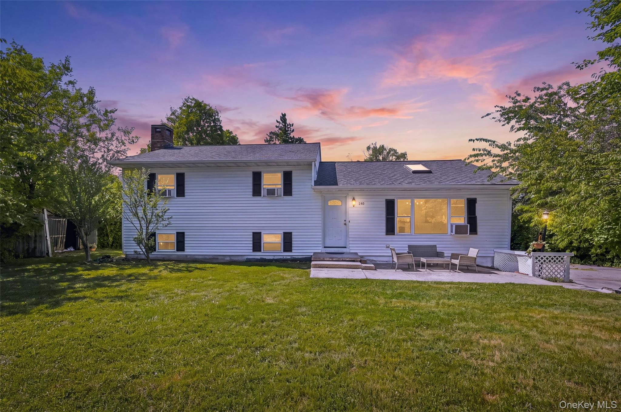 249 Ridge Road Highland Mills, NY 10930 - Photo 1 of 38 White siding residence featuring a prominent front lawn and a concrete patio
