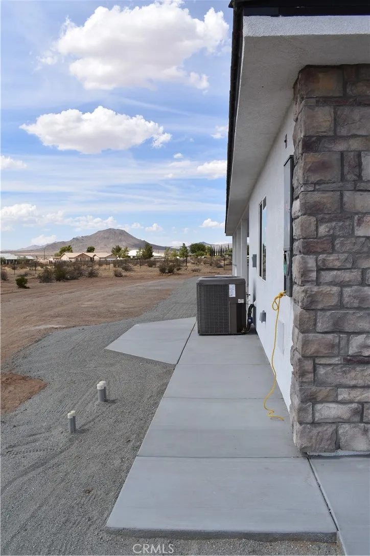 16944 Pauhaska Road Apple Valley, CA 92308 - Photo 12 of 74 a view of a patio with wooden floor and city view