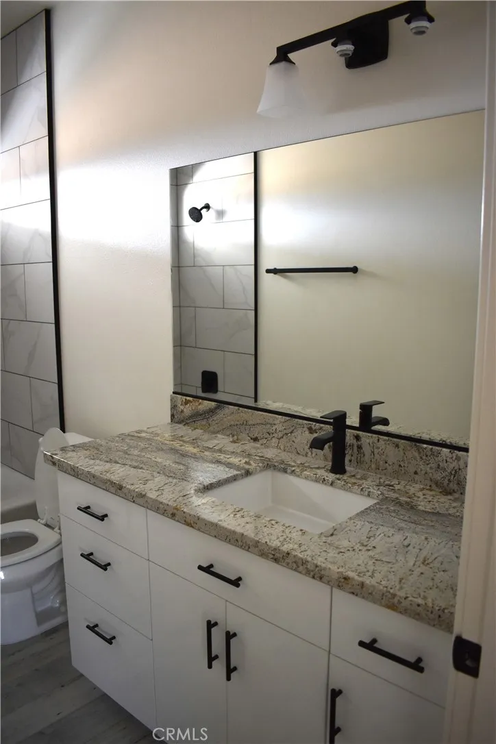16944 Pauhaska Road Apple Valley, CA 92308 - Photo 37 of 74 a bathroom with a granite countertop sink and a mirror