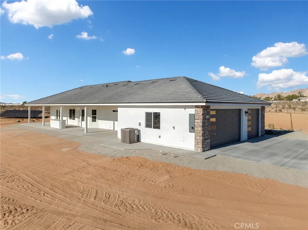 16944 Pauhaska Road Apple Valley, CA 92308 - Photo 55 of 74 a front view of a house with a garage