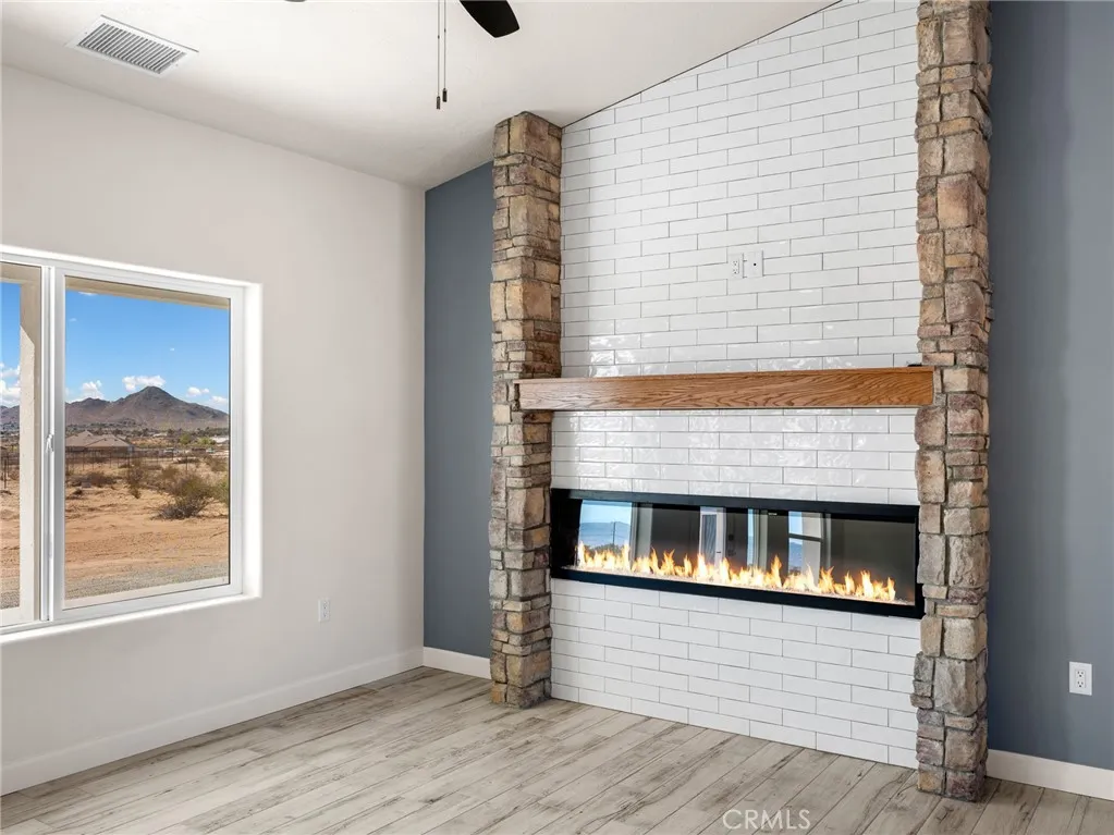 16944 Pauhaska Road Apple Valley, CA 92308 - Photo 63 of 74 a living room with furniture and a fireplace