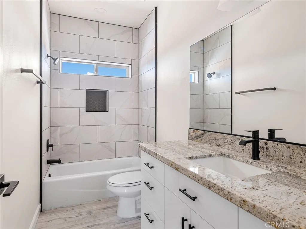 16944 Pauhaska Road Apple Valley, CA 92308 - Photo 71 of 74 a bathroom with a granite countertop sink a toilet and shower