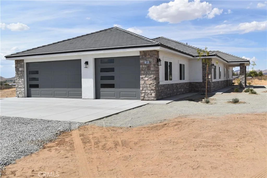 16944 Pauhaska Road Apple Valley, CA 92308 - Photo 9 of 74 a front view of a house with a yard