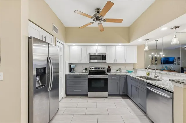 a front view of a house with a yard and palm trees