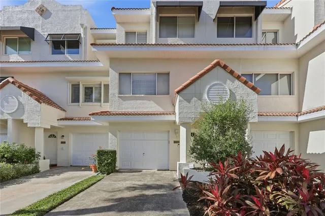a kitchen with stainless steel appliances granite countertop a sink and a refrigerator