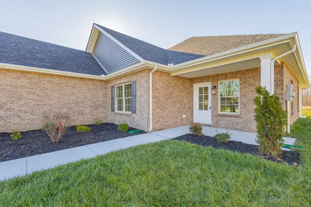 a bathroom with a granite countertop sink and a toilet