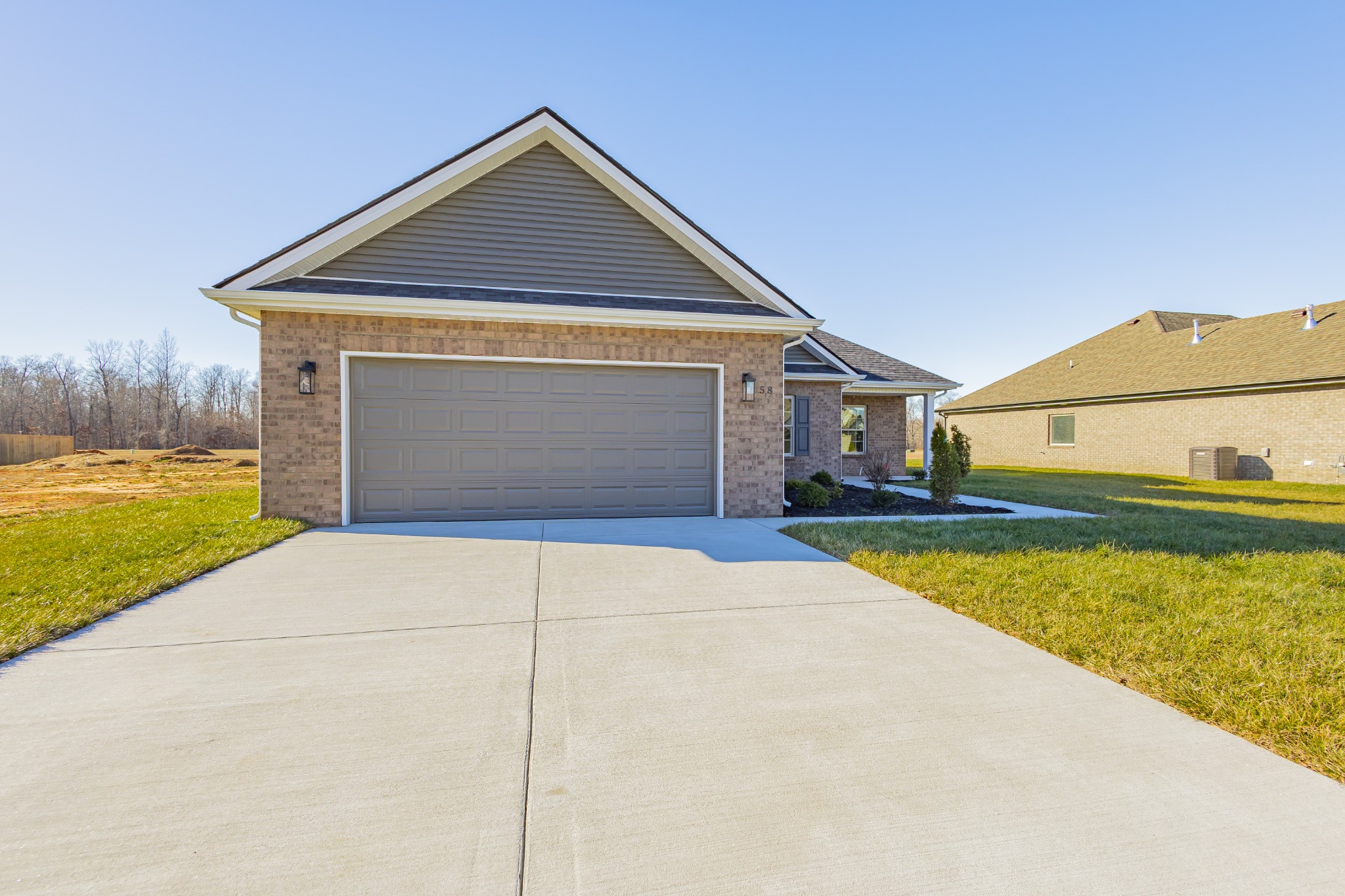 58 Brooklyn Avenue Manchester, TN 37355 - Photo 4 of 62 a front view of a house with a yard and garage