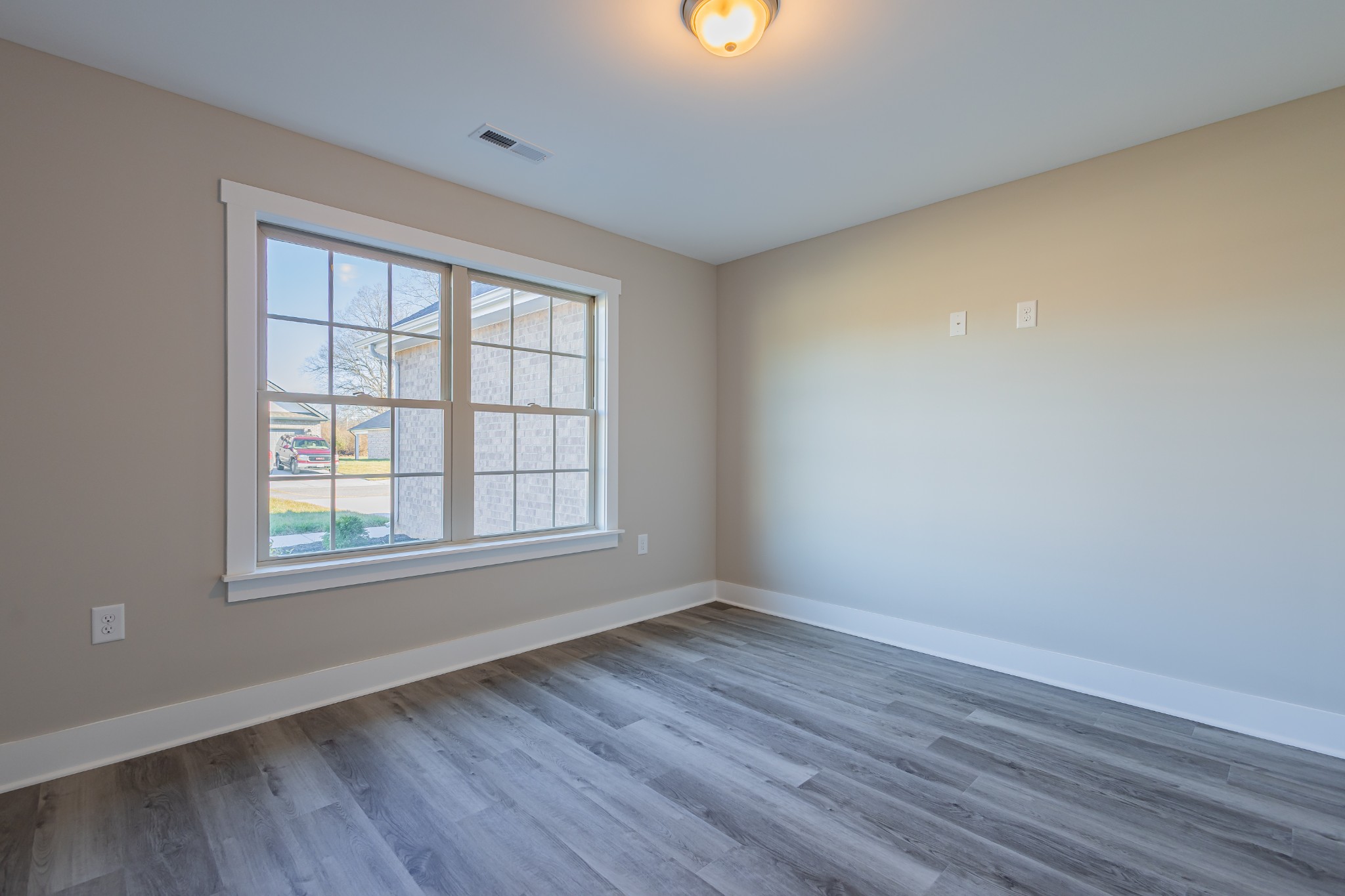 58 Brooklyn Avenue Manchester, TN 37355 - Photo 52 of 62 a view of an empty room with wooden floor and a window