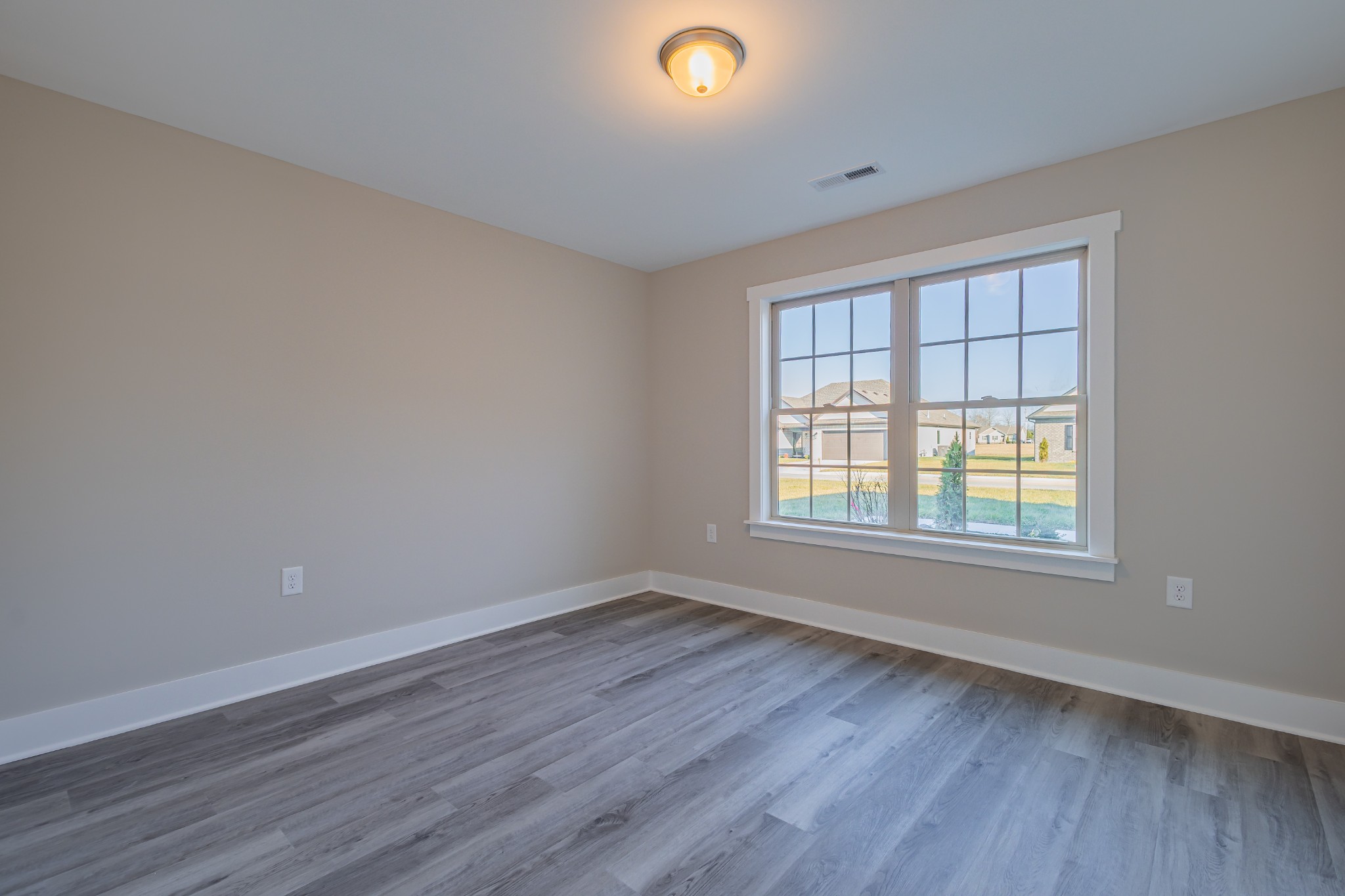 58 Brooklyn Avenue Manchester, TN 37355 - Photo 54 of 62 a view of an empty room with wooden floor and a window