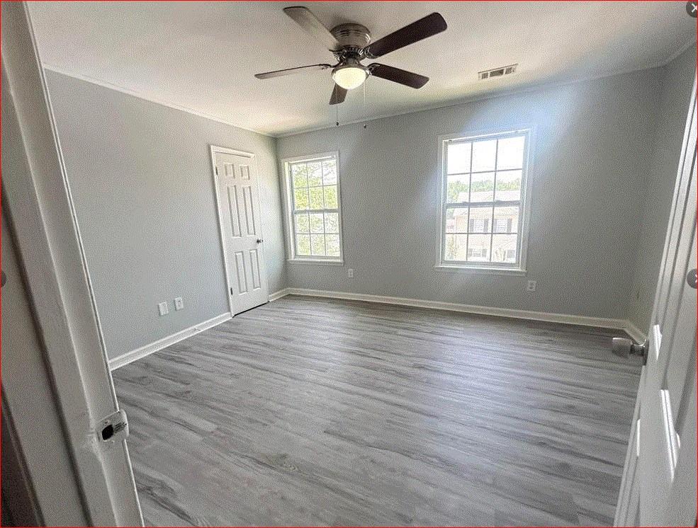1021 Thorn Woode Lane Stone Mountain, GA 30083 - Photo 6 of 6 a view of an empty room with a window and wooden floor