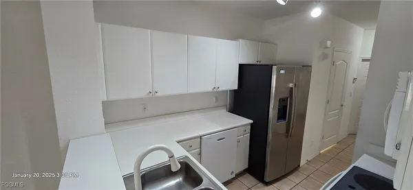 a kitchen with refrigerator and window
