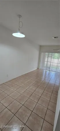 a view of an empty room and a window