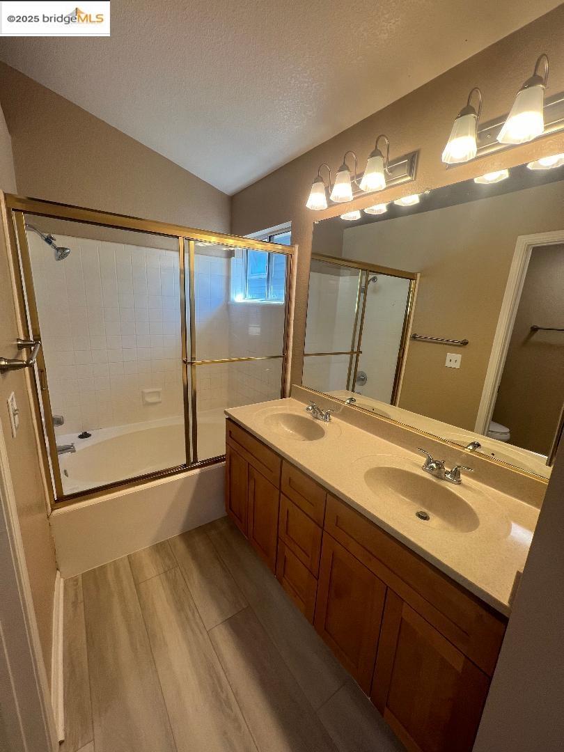 5016 Perry Way Antioch, CA 94531 - Photo 14 of 16 a bathroom with a double vanity sink and mirror