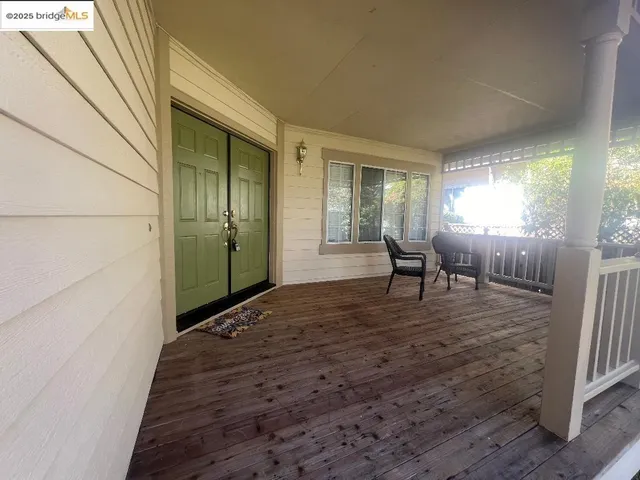 a view of a livingroom with wooden floor and furniture