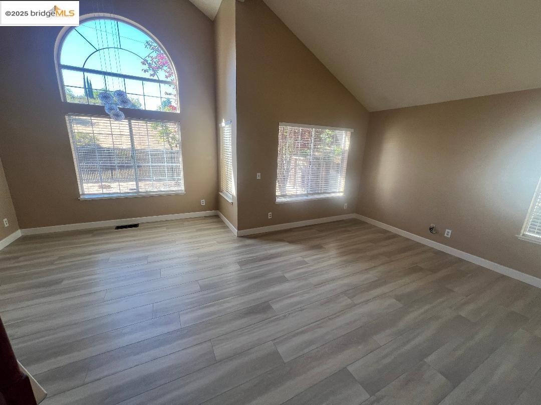 5016 Perry Way Antioch, CA 94531 - Photo 3 of 16 an empty room with wooden floor and windows