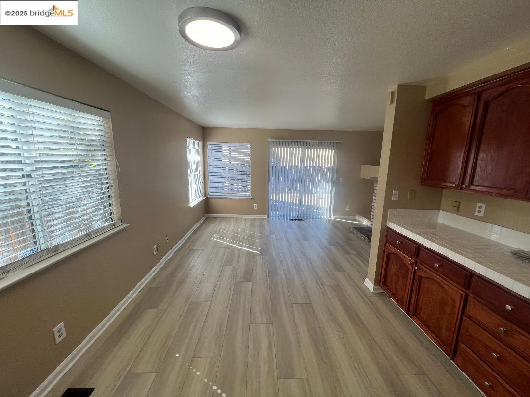 5016 Perry Way Antioch, CA 94531 - Photo 7 of 16 a view of a kitchen with wooden floor and cabinets