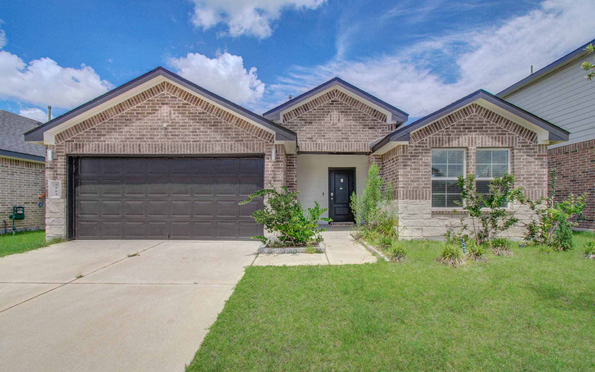 7903 Wrangler Shack Lane Rosharon, TX 77583 - Photo 4 of 29 Discover the charm of this modern, single-story brick home featuring a spacious two-car garage, a neat front lawn, and a welcoming covered entrance that exudes inviting curb appeal.