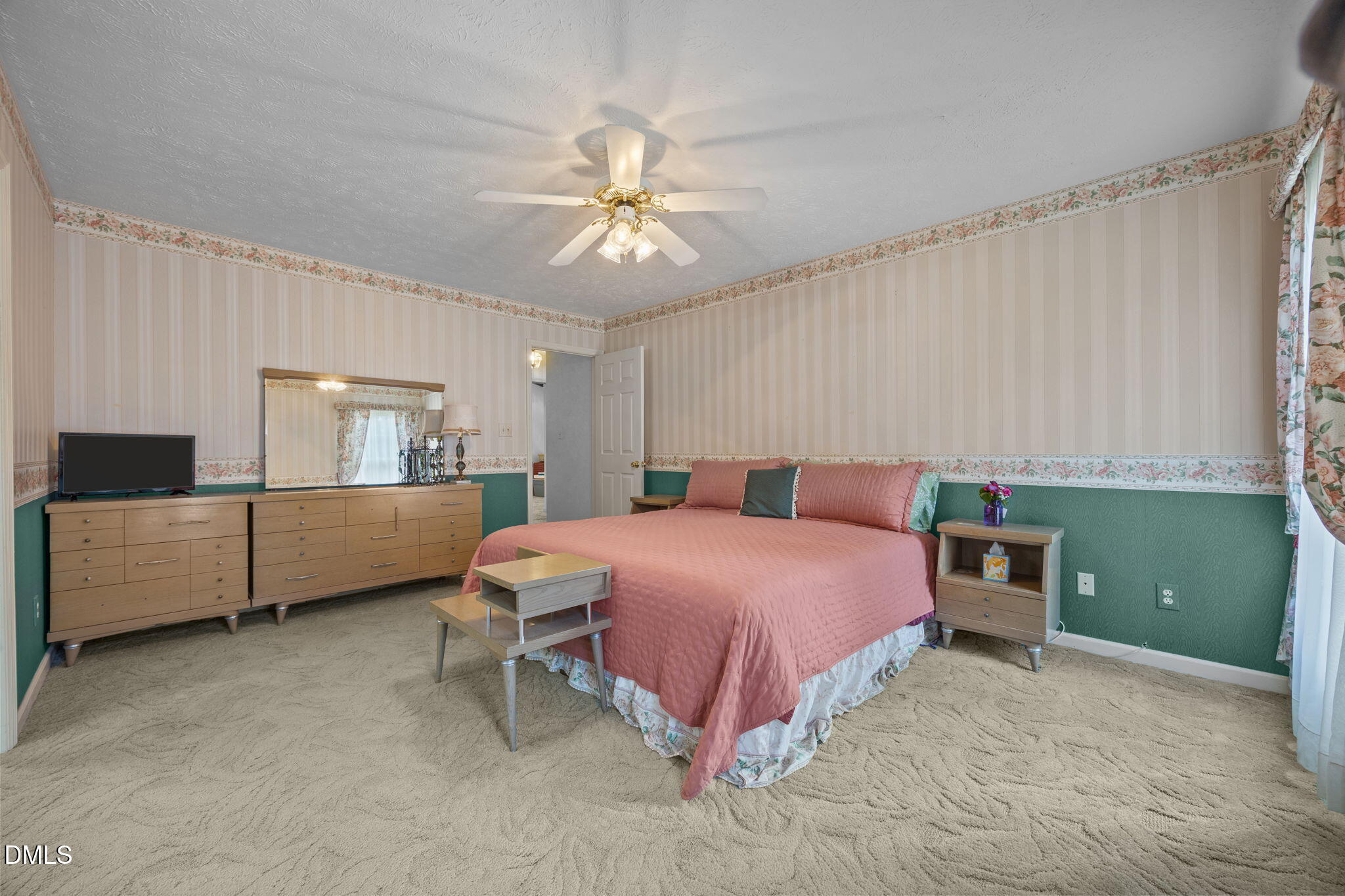 69 Deer Run Court Angier, NC 27501 - Photo 14 of 40 a bedroom with a bed and a chandelier