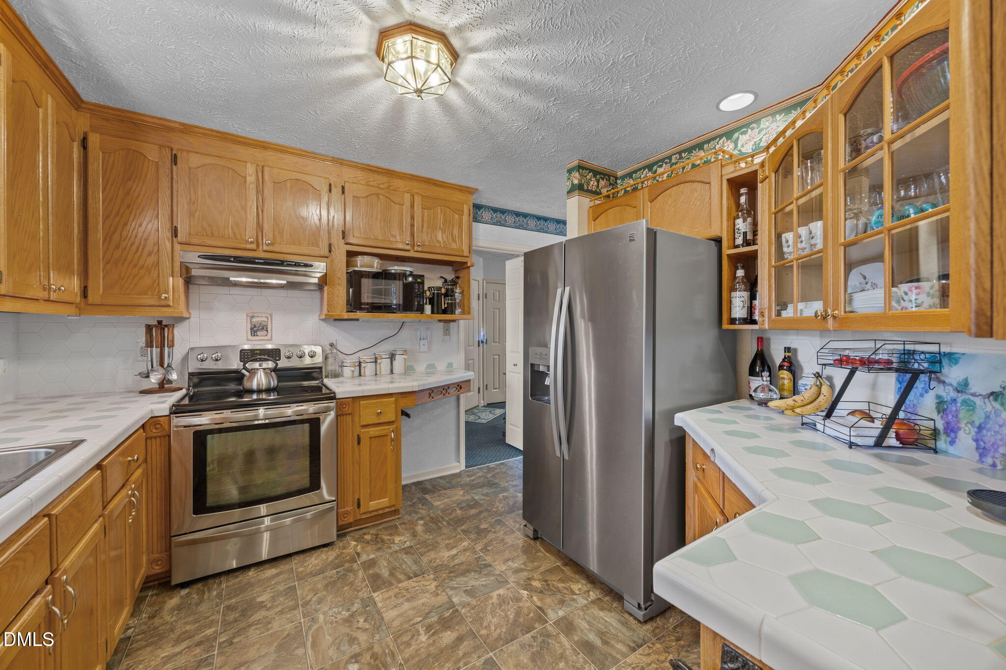 69 Deer Run Court Angier, NC 27501 - Photo 16 of 40 a kitchen with stainless steel appliances granite countertop a refrigerator a stove top oven a sink and dishwasher