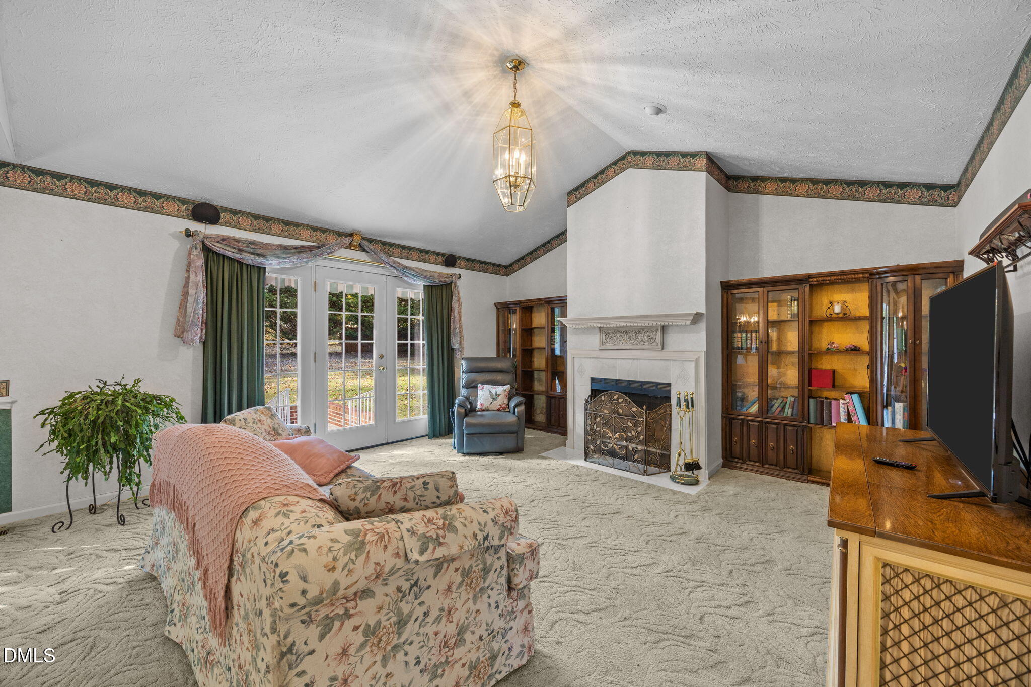 69 Deer Run Court Angier, NC 27501 - Photo 5 of 40 a living room with furniture a fireplace and a flat screen tv