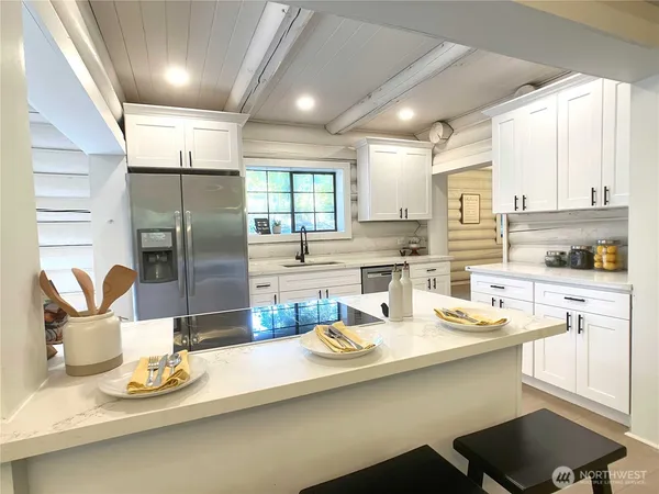 a kitchen with stainless steel appliances kitchen island granite countertop a sink and cabinets