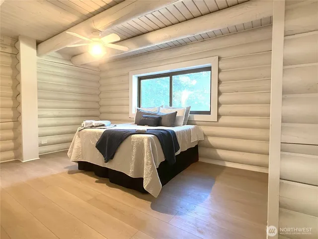 a bedroom with a bed and a large window