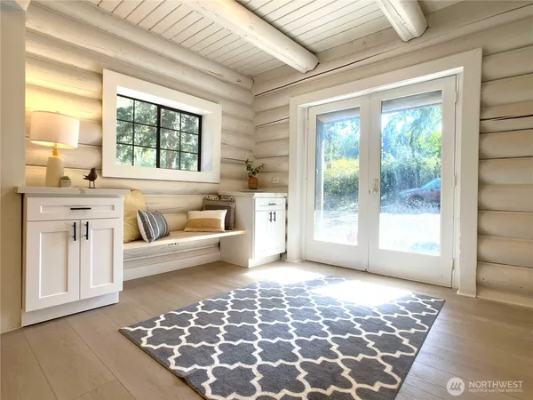 a living room with a black white checkered floor next to a window