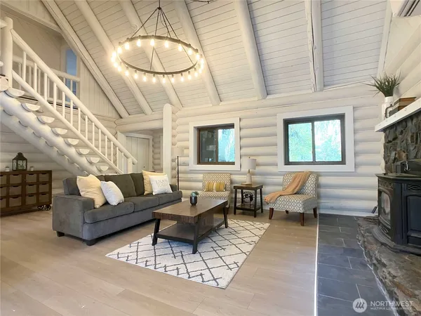 a living room with furniture a fireplace and a chandelier