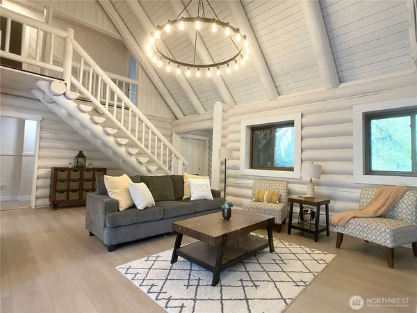 a living room with furniture and a chandelier