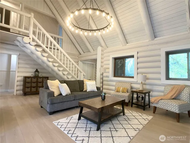 a living room with furniture and a chandelier