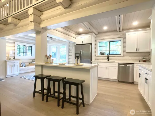 a kitchen with a sink cabinets and chairs